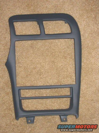 Dark gray plastic center console trim piece with openings for radio and climate controls