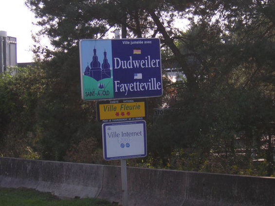 Town signs for Dudweiler, Fayetteville, Ville Fleurie, and Ville Internet