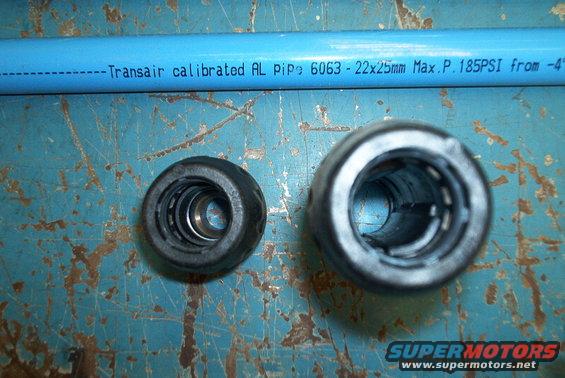 Blue Transair pipe and two metal fittings on a blue surface