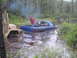 1995 Dodge 1500 - A blue 1995 Dodge 1500 is stuck in water, with a military truck assisting.