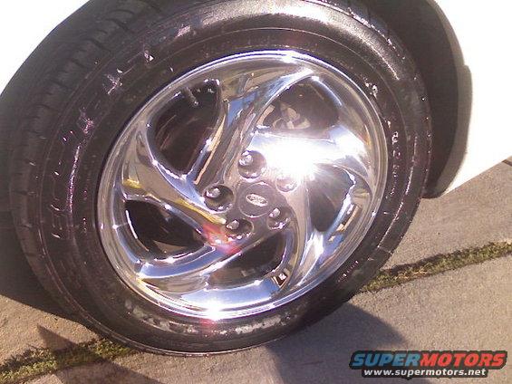 Chrome wheel with five spokes and a tire