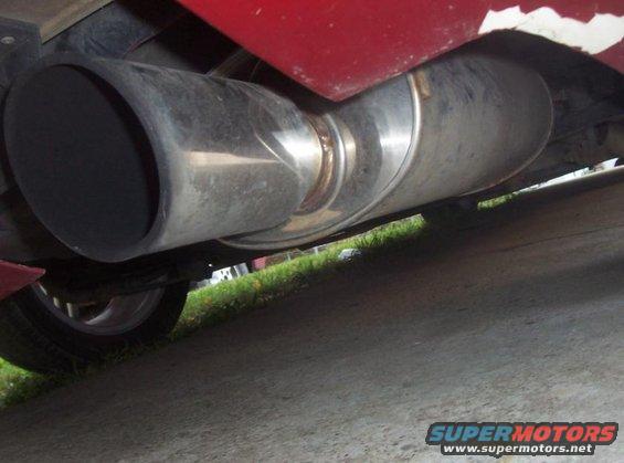Red car's large exhaust pipe and muffler