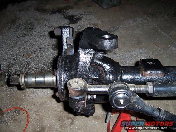 Close-up of a steering linkage assembly with tie rods and ball joints
