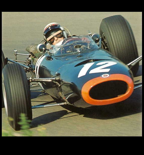 Blue and orange race car with number 12, driver wearing helmet and sunglasses