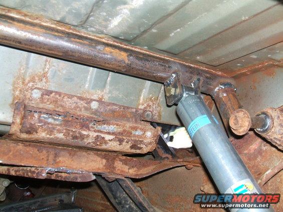 Underbody view of a vehicle with a new Bilstein shock absorber and custom frame reinforcement