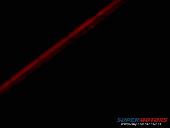 Diagonal red line on black background with SUPERMOTORS.NET watermark