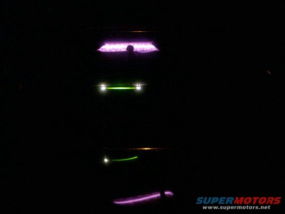 Car lights at night, with purple and green illumination
