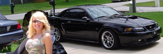 Black 2003 Ford Mustang with a woman in the foreground