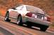 2003 Ford Mustang - Silver 2003 Ford Mustang SVT Cobra seen from the rear on a road.