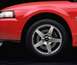2003 Ford Mustang - Close-up of a red 2003 Ford Mustang SVT's front wheel and fender.
