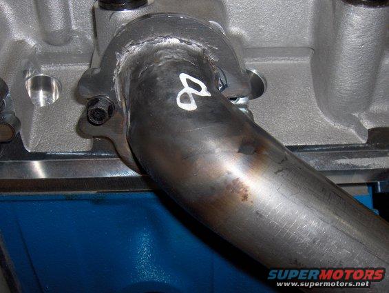 Crites headers. Average quality. This is a ground-down weld covering burnthrough holes in the header tube. On the inside of this weld is slag hanging in the tube. I had to grind down several welds inside the header tubes.