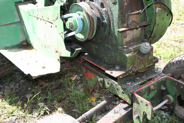 Green machinery part with pulley and belt, close-up view