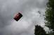 1987 Ford Bronco - A red barrel appears to be flying through the sky, with trees visible on the right side.