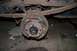 1987 Ford Bronco - Close-up of a vehicle's rusty rear drum brake assembly and suspension.