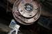 1987 Ford Bronco - Close-up of a vehicle's drum brake assembly, with a jack stand and cat litter bucket visible.