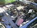 2003 Mercury Marauder - The engine bay of a black car, an aftermarket air intake system and a V8 engine.