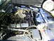 2003 Mercury Marauder - The engine bay of a 2003 Mercury Marauder shows its V8 engine and "POWERED BY FORD" valve covers.