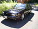 2003 Mercury Marauder - A black 2003 Mercury Marauder is seen from a three-quarter front view, parked on a paved surface with a residential background.