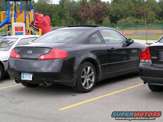 Black Infiniti G35 coupe parked next to a Volvo S60. Playground in background
