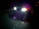 2003 Mercury Marauder - A dark sedan is seen from the front at night, its headlights illuminating the road ahead.