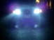 2003 Mercury Marauder - A car's bright headlights illuminate the dark, with a visible license plate.