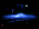 2003 Mercury Marauder - Headlights cast a blue glow on a dark street at night, with a house and mailbox in the background.