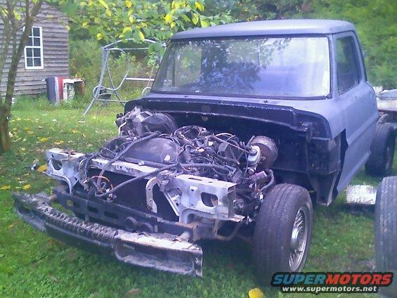 Truck front end disassembled, engine exposed, gray primer