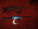 1988 Ford Bronco - Two firearms, a black rifle and a blue paintball gun, are displayed on a red carpet.