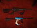 1988 Ford Bronco - Two firearms, one black rifle and one blue paintball gun, are displayed on a red carpeted surface.