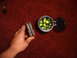 1988 Ford Bronco - A hand holds an ammunition clip filled with bullets, positioned next to an open container filled with marbles.