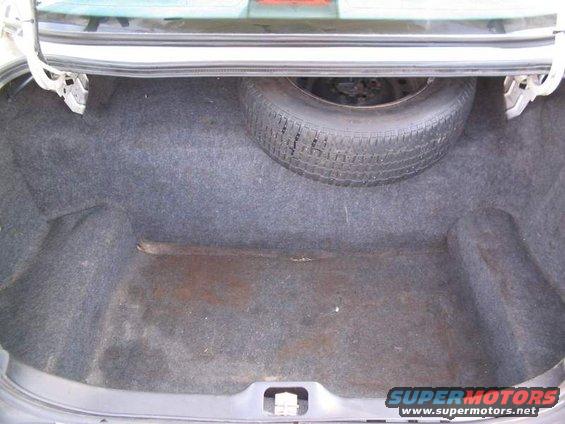 1998 Ford Crown Victoria trunk interior with spare tire mounted on the right