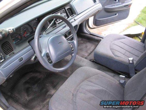 Interior view of a 1998 Ford Crown Victoria, showing the dashboard, steering wheel, and front seats