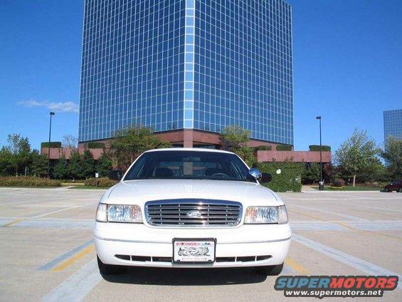 1998 Ford Crown Victoria front view, parked in lot with office building behind