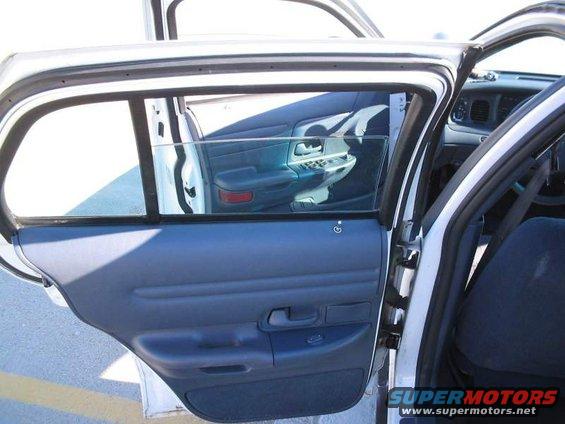 Interior door panel and reflection of dashboard in a white car