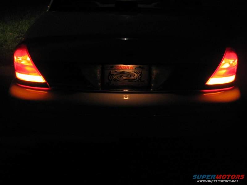 1998 Ford Crown Victoria rear with illuminated taillights and a license plate