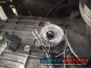 Close-up of a vehicle transmission part with wires and a connector