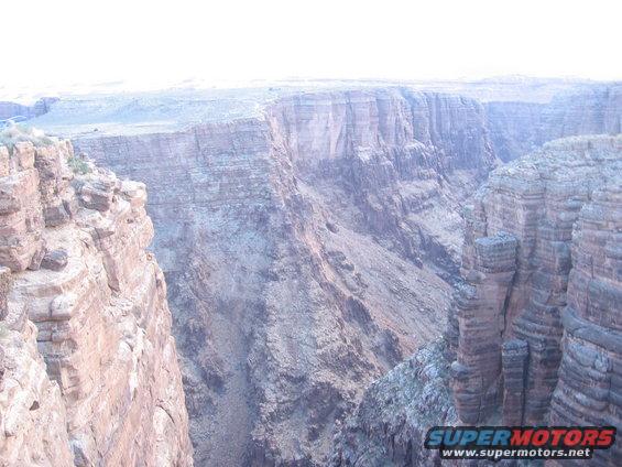 Grand Canyon landscape with layered rock formations under a bright sky