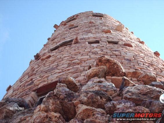 Stone tower against a blue sky, with rocks in the foreground. Date stamp reads 02/11/2005