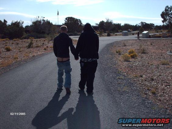 Two people walk away on a path, date stamp 02/11/2005