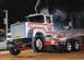 1994 Ford F-150 - Custom semi-truck competes in a truck pull event, kicking up smoke.