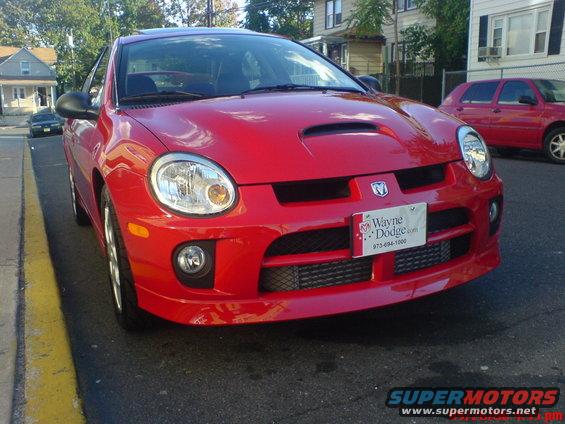 Red 2005 Dodge SRT-4 parked on street, front view. Wayne Dodge license plate visible