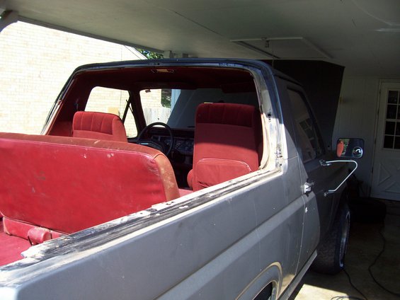 Interior of gray SUV with red seats and open hood