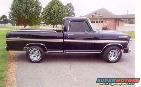 Side view of a black Ford Ranger XLT pickup truck with chrome trim and aftermarket wheels