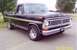 2002 Ford Crown Victoria - This black Ford pickup truck features a prominent chrome grille and dual headlights, with a hog emblem on the front bumper.