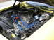 1978 Ford Ranchero - The engine bay of a yellow 1978 Ford Ranchero features Ford Racing valve covers and bright blue spark plug wires.
