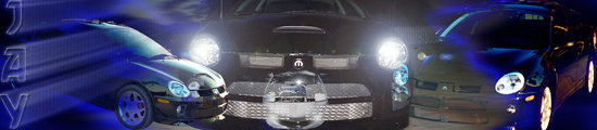 Three Dodge Neons lined up, two dark blue and one black, with headlights on