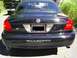 2003 Mercury Marauder - Rear view of a 2003 Mercury Marauder, with a pickup truck behind it.