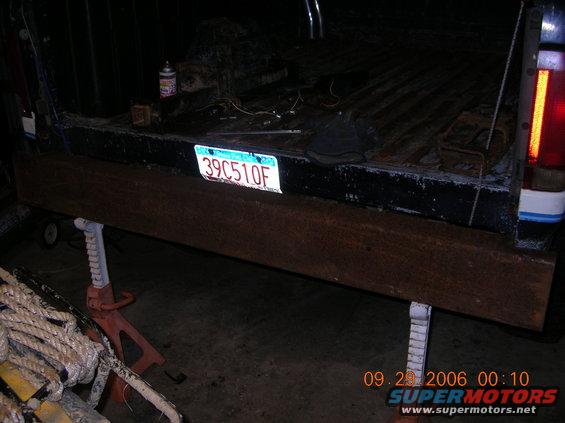 1991 Ford F-150 rear with license plate 39C510F and a wooden plank supported by jack stands