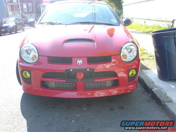 Red 2005 Dodge SRT-4 front view with hood scoop and yellow fog lights