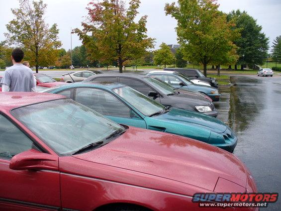 Red 1991 Ford Probe in a parking lot, front view. Other cars are parked in the background